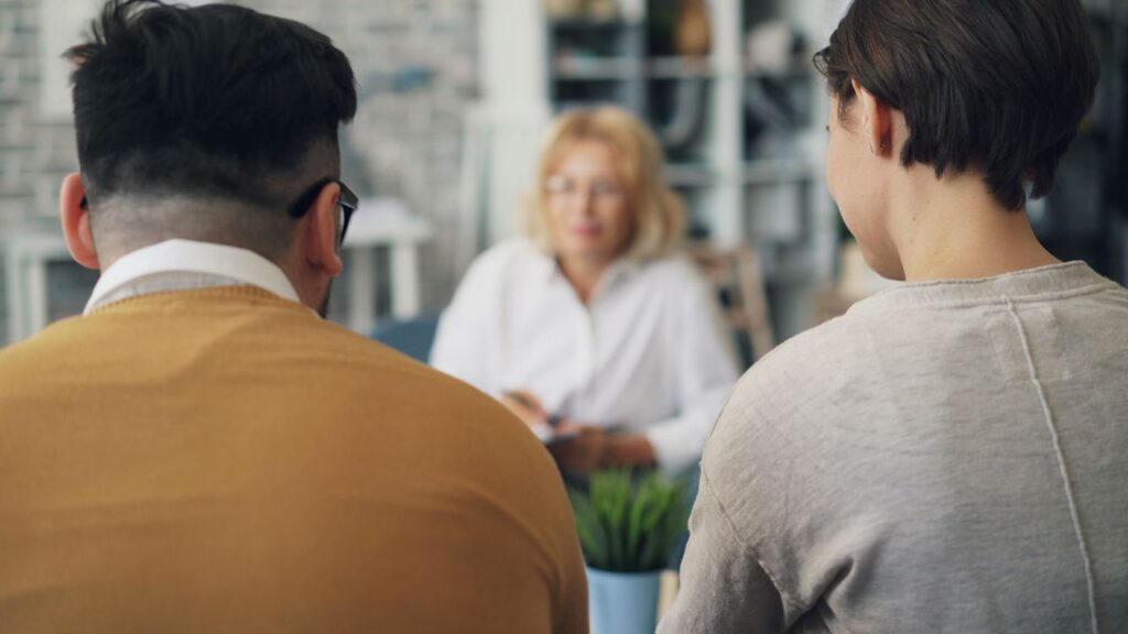 A couple engages in a counseling session with a therapist, focusing on relationship guidance.