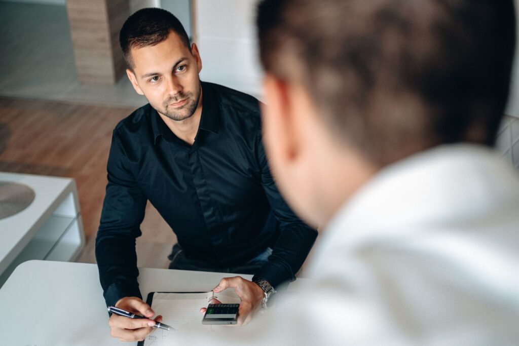 Men collaborating in an office setting, focused on planning and strategy.